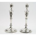 A pair of George III silver table candlesticks, each with a tapered column,