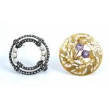A Scottish 9ct gold and amethyst set circular brooch, designed as a twin thistle spray,