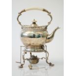 A silver tea kettle, stand and burner,