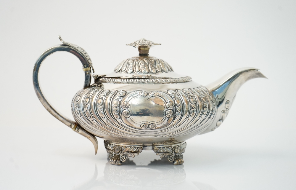 A George IV silver teapot, of compressed circular form,