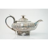 A George IV silver teapot, of compressed circular form,