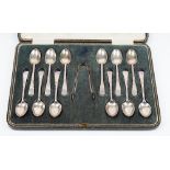 A set of twelve silver coffee spoons and a matching pair of silver sugar tongs,