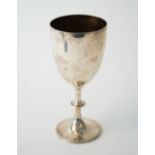 A Victorian silver trophy goblet, raised on a circular foot, decorated with a beaded rim,