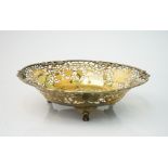 A silver gilt dish, of shaped circular form, cast and pierced with a border of fruiting vine,