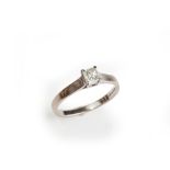 An 18ct white gold ring, claw set with a princess cut diamond, ring size M and a half,