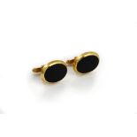 A pair of 9ct gold mounted black onyx cufflinks,