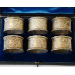 Six Victorian silver napkin rings, each with engraved decoration within beaded rims, numbers 4,