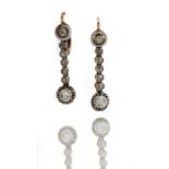 A pair of diamond set pendent earrings, the old mine cut diamond set within a halo mount,