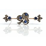 A gold and silver set, diamond and sapphire brooch, the centre with a trefoil shaped motif,