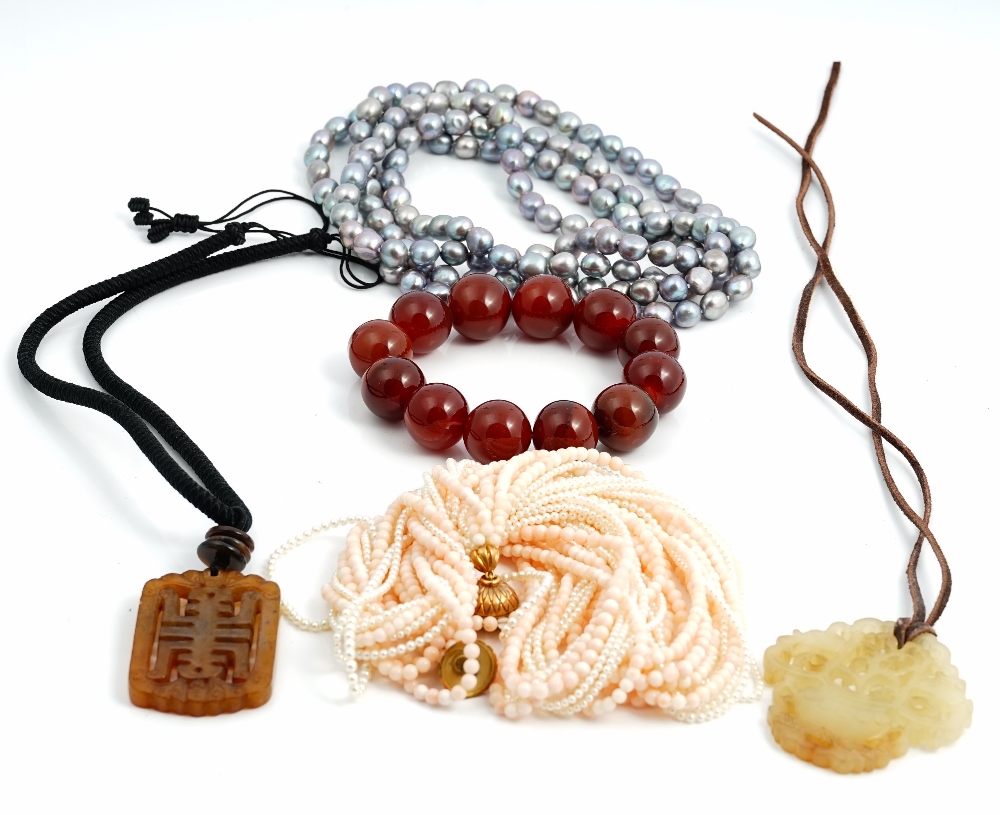A multiple row necklace of five rows of coral beads and seven rows of small cultured pearls,