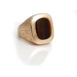 A gold and tiger's eye gentleman's signet ring, mounted with a curved rectangular tiger's eye,