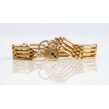 A gold decorated and plain bar and oval link gate bracelet, detailed 15 C, weight 12.