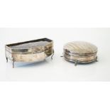 A silver hinge lidded circular trinket box, the domed lid decorated with engine turned bands,