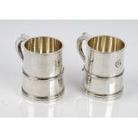 A pair of silver mugs, each of tapered cylindrical form in the 18th century taste,
