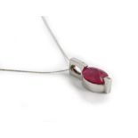 An 18ct white gold pendant, claw set with an oval cut treated pink sapphire,