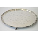 A large silver salver, of shaped circular form, having a pie-crust rim within a gadrooned border,