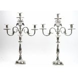 A pair of French three light table candelabra, each light with an octagonal drip pan,