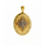A Victorian gold and diamond set hinged locket pendant of oval design,