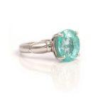 An 18ct white gold ring, claw set with an oval cut, paraiba tourmaline, gross weight 4.