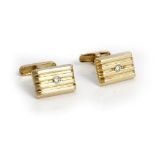 A pair of gold and colourless gem set cufflinks,