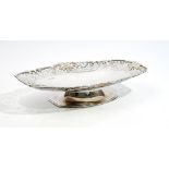 A silver fruit dish, of tapered oval form, the wide rim cast and pierced with fruiting vine,