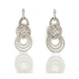 A pair of white gold and diamond set pendant earrings, each in a graduated openwork looped design,