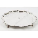 A silver salver of shaped circular form,