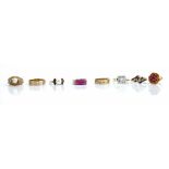 A 9ct gold, ruby and colourless gem set ring, in a twist design, a 9ct gold wedding band ring,