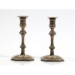 A pair of late Victorian small candlesticks, modelled as mid-18th century taper sticks,