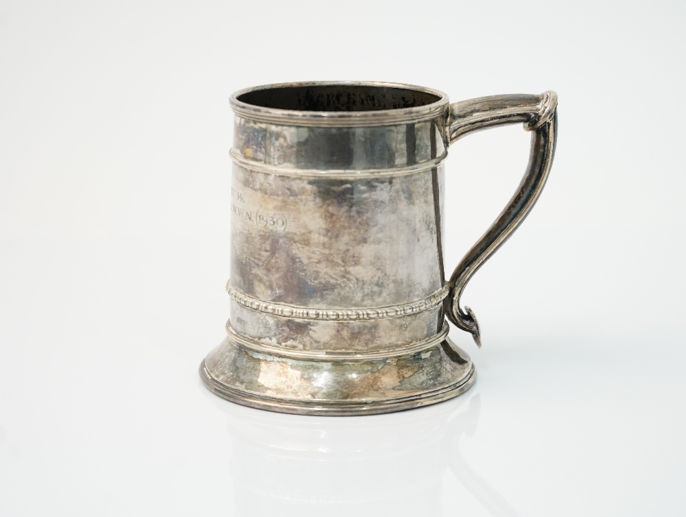 An Omar Ramsden silver mug, of tapered cylindrical form, raised on a flared circular foot,