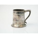 An Omar Ramsden silver mug, of tapered cylindrical form, raised on a flared circular foot,