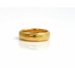 A late Victorian 22ct gold plain wedding band ring, ring size M, London 1897, weight 8.1 gms.
