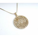 A gold and colourless gemset circular pendant, in a pierced abstract design, detailed Favori 585,