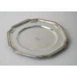 A Mexican main course plate, of shaped circular form, the rim decorated with foliate sprays,