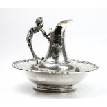 A French silver toilet jug and bowl, the jug decorated to the body with two oval reserves,