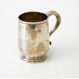 A silver mug, of tapered cylindrical form, the handle with a heart shaped terminal,