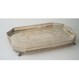 A Victorian silver plated twin handled gallery tray with engraved decoration,