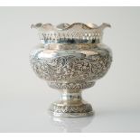 A foreign vase with floral and foliate scroll embossed decoration,