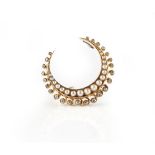 A gold, diamond and half pearl set brooch, designed as a crescent,