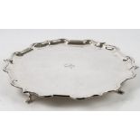 A silver salver of shaped circular form,