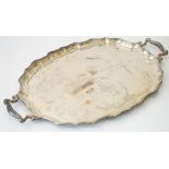 A silver twin handled shaped oval tray,