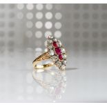 A gold, ruby and diamond set marquise shaped cluster ring,