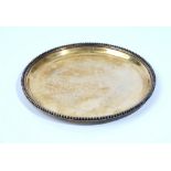 A French silver gilt circular salver, decorated with a beaded rim, detailed Cardeilhac Paris,