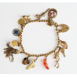 A gold charm bracelet, on an 18ct gold heart shaped padlock clasp,
