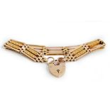 A gold decorated and plain bar and oval link gate bracelet, detailed 9ct,