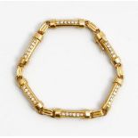 A French gold and diamond bracelet, formed as a row of curved baton shaped links,