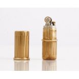 A Cartier London 9ct gold cased petrol lighter, of cylindrical form, with banded decoration,