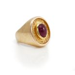 A 9ct gold and cabochon ruby single stone ring, mounted with an oval cabochon ruby,