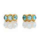 A pair of two colour gold and cabochon aquamarine three stone earclips,