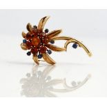A 9ct gold, citrine and sapphire brooch, designed as a flower spray,